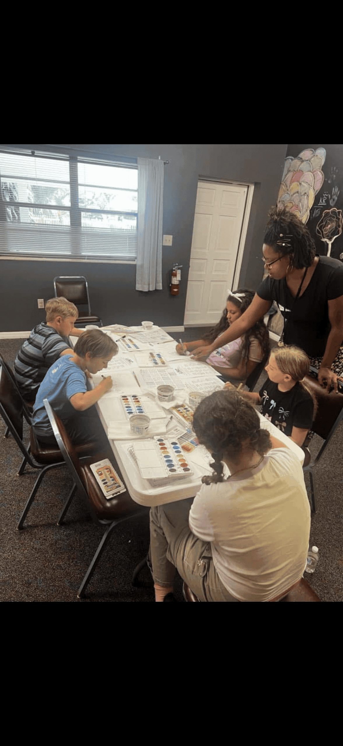 Teacher lead art class at Arise and Shine Christian Academy.