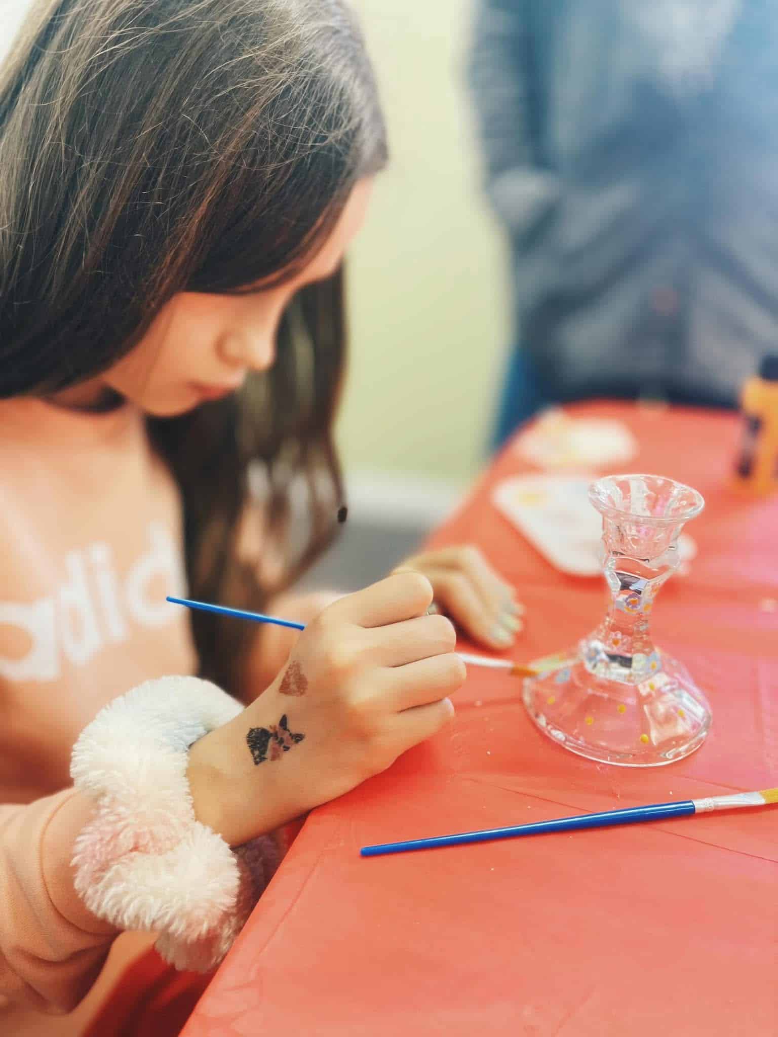 young-girl-painting-on-candle-holders